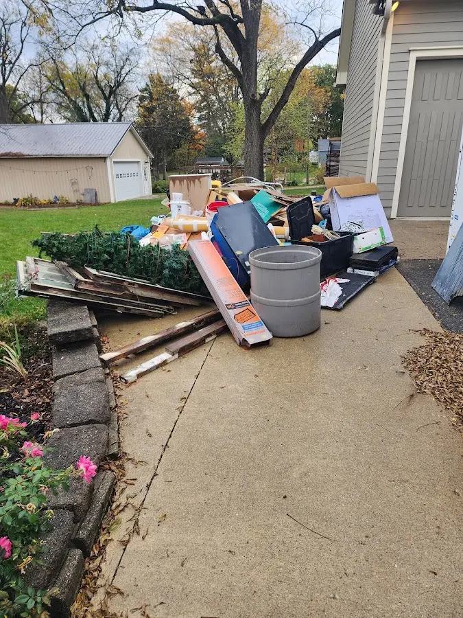 Dumpster being loaded with debris for Demolition Dumpster Rental in Loganville